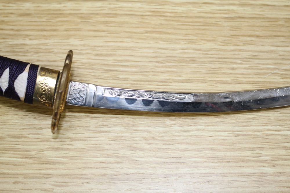 A Japanese late Meiji period set of lacquered model weapons on display stands, comprising archers bow, samurai sword and other weapons